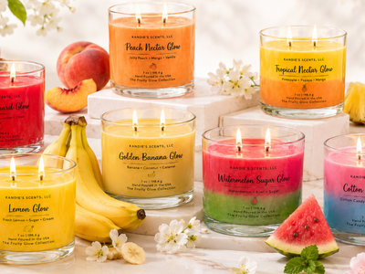 Fruity Glow Collection by Kandie's Scents all 7 summer hand poured candles displayed with fresh fruit on a marble surface shop at shopwithkandie.com