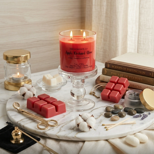 Candle and wax melts on a marble tray with books and decorative items.