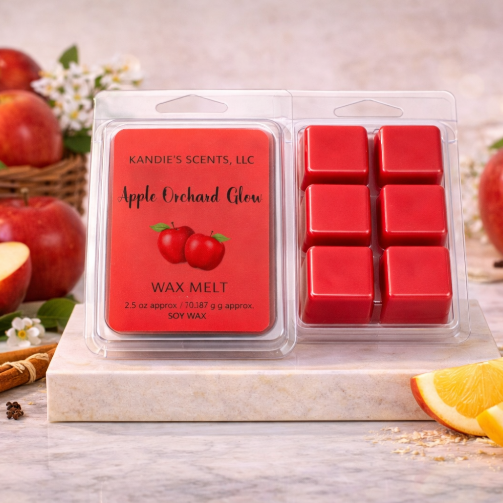 Kandie's Scents Apple Orchard Glow wax melts packaging with apples and oranges in the background