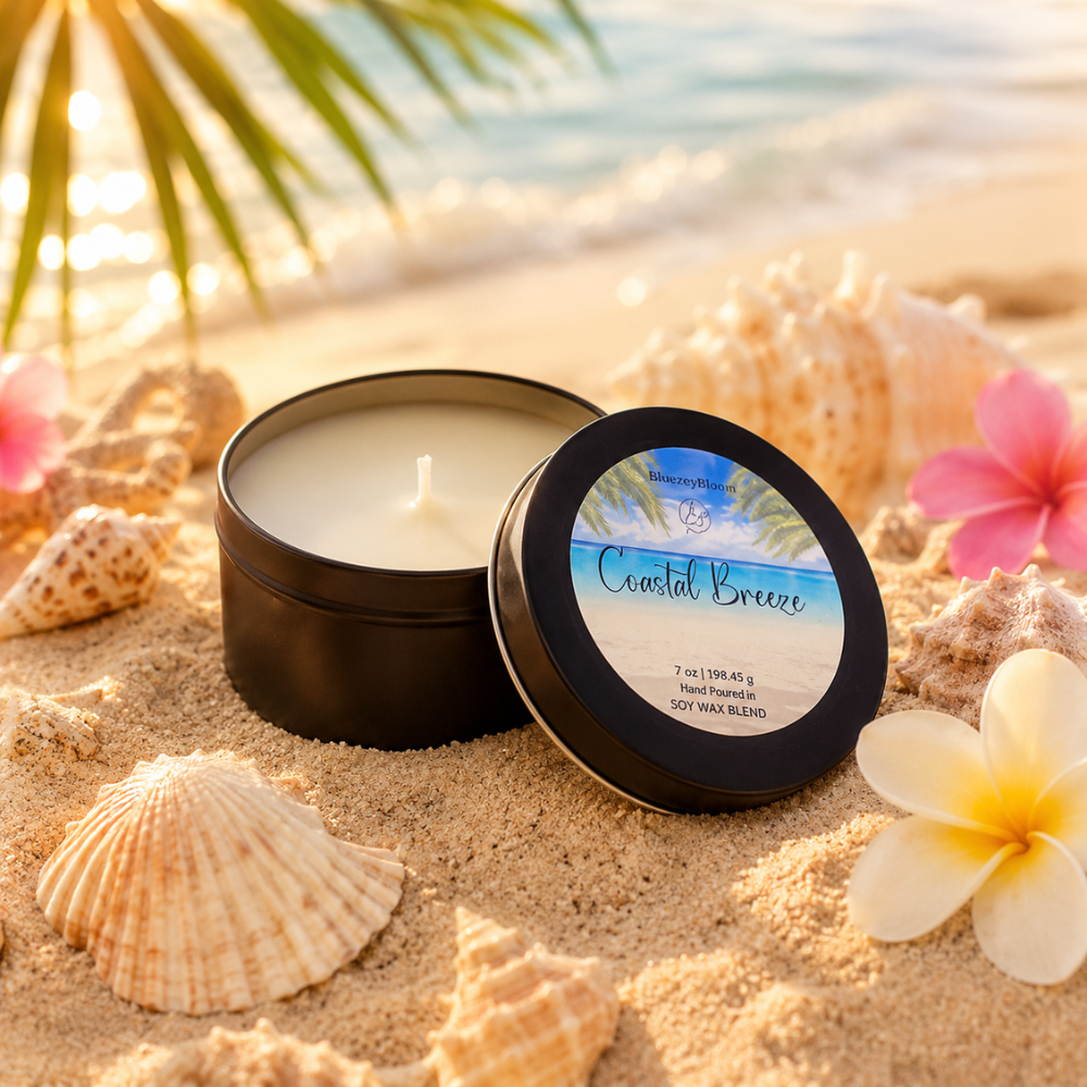 Candle in a tin with a beach-themed label on a sandy background with shells and flowers