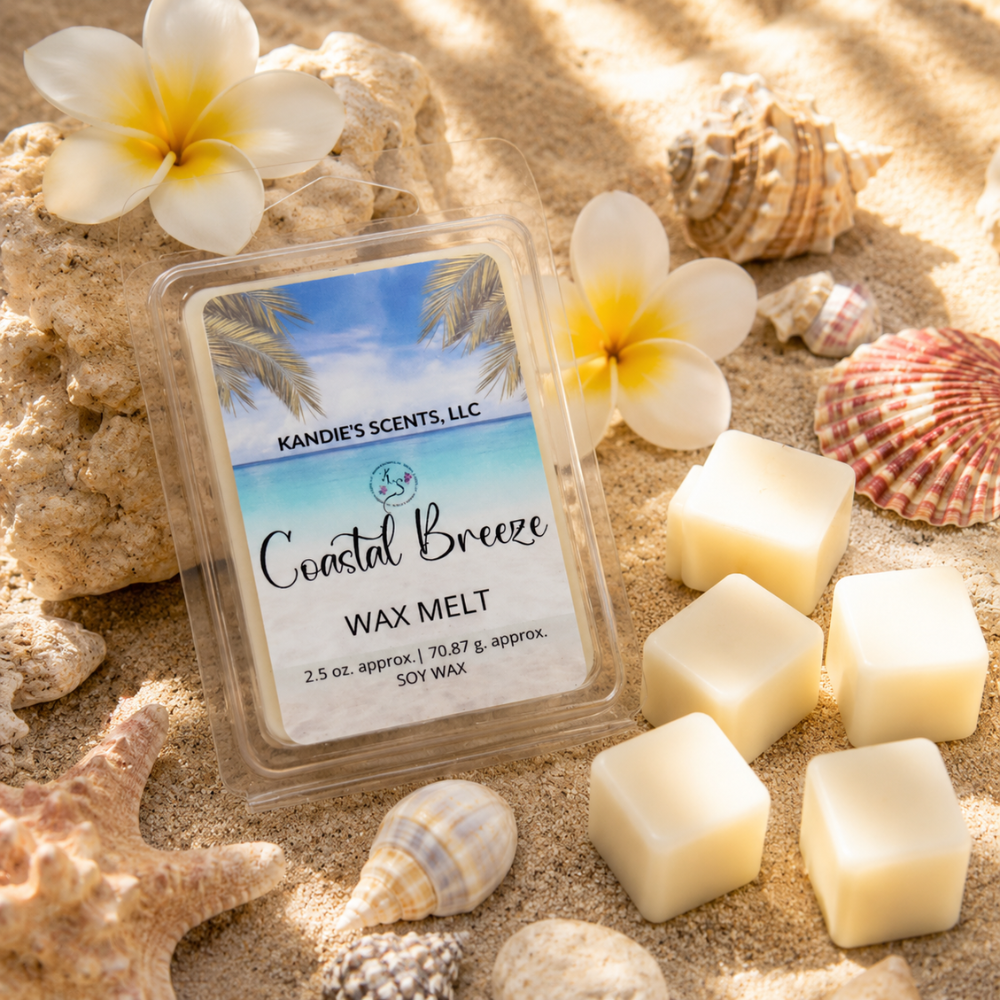 Kandie's Scents Coastal Breeze wax melt packaging on sand with flowers and shells