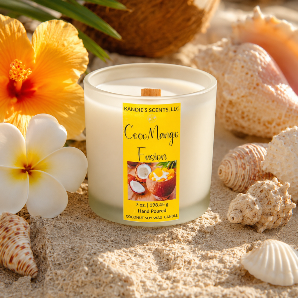 Candle labeled 'CocoMango Fusion' surrounded by seashells and flowers on sand