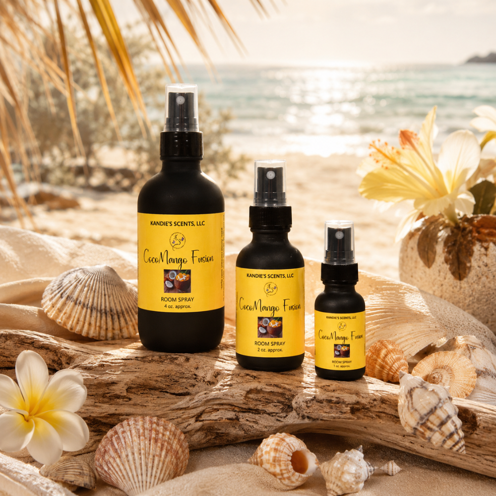 Three bottles of 'Coco Mango Fusion' room spray on a beach setting with shells and flowers.