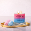 Candle labeled 'Cotton Candy Glow' on a gold tray with cotton candy beside it.