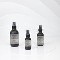 Ember Woods room spray bottles with citrus and earthy notes