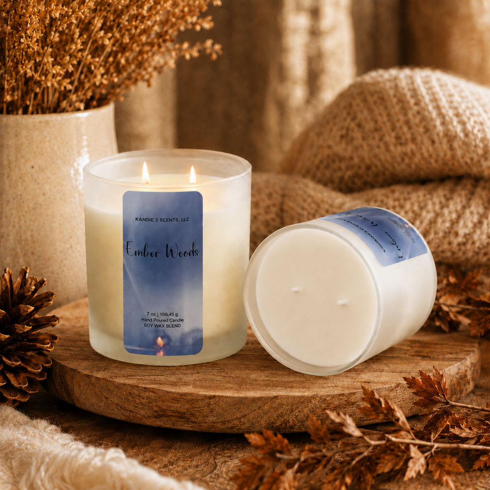 Two Ember Woods candles by Kandie's Scents with a cozy fall scene.