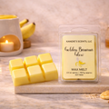 Kandie's Scents LLC Golden Banana Glow wax melts with packaging on a wooden surface.