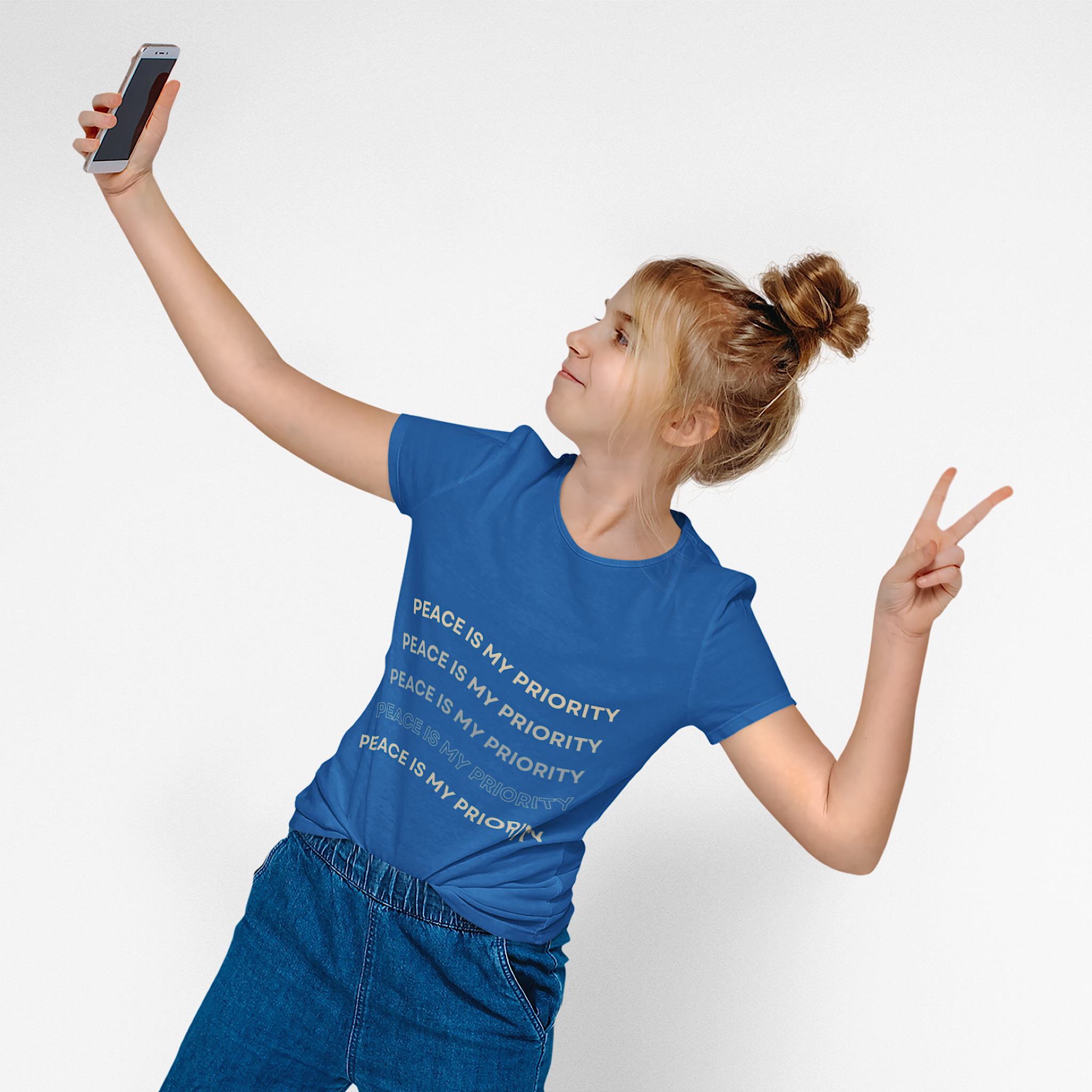 Person wearing a blue t-shirt with 'Peace is my priority' text, taking a selfie on a white background