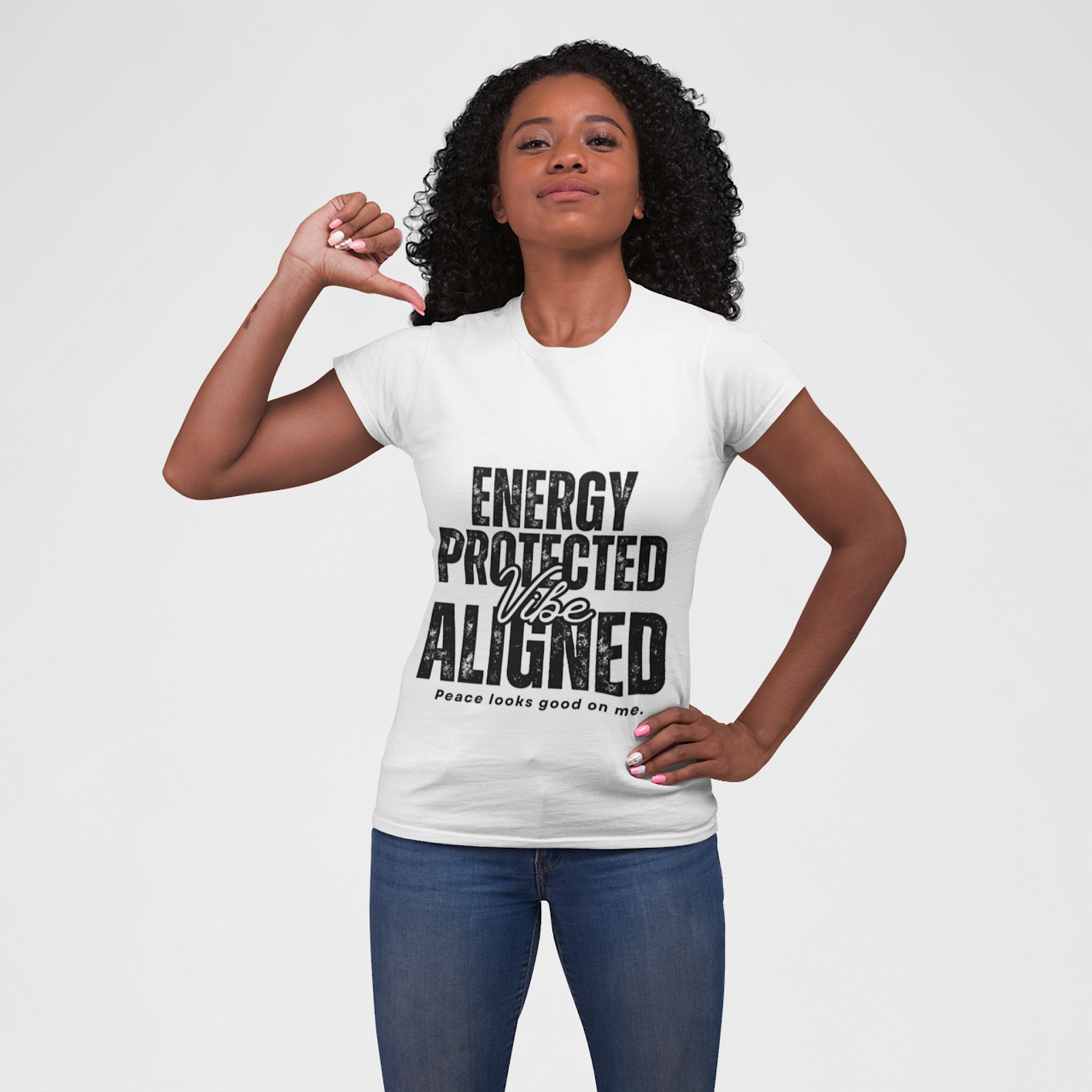 Woman wearing a white t-shirt with 'Energy Protected Vibe Aligned' text on a plain background