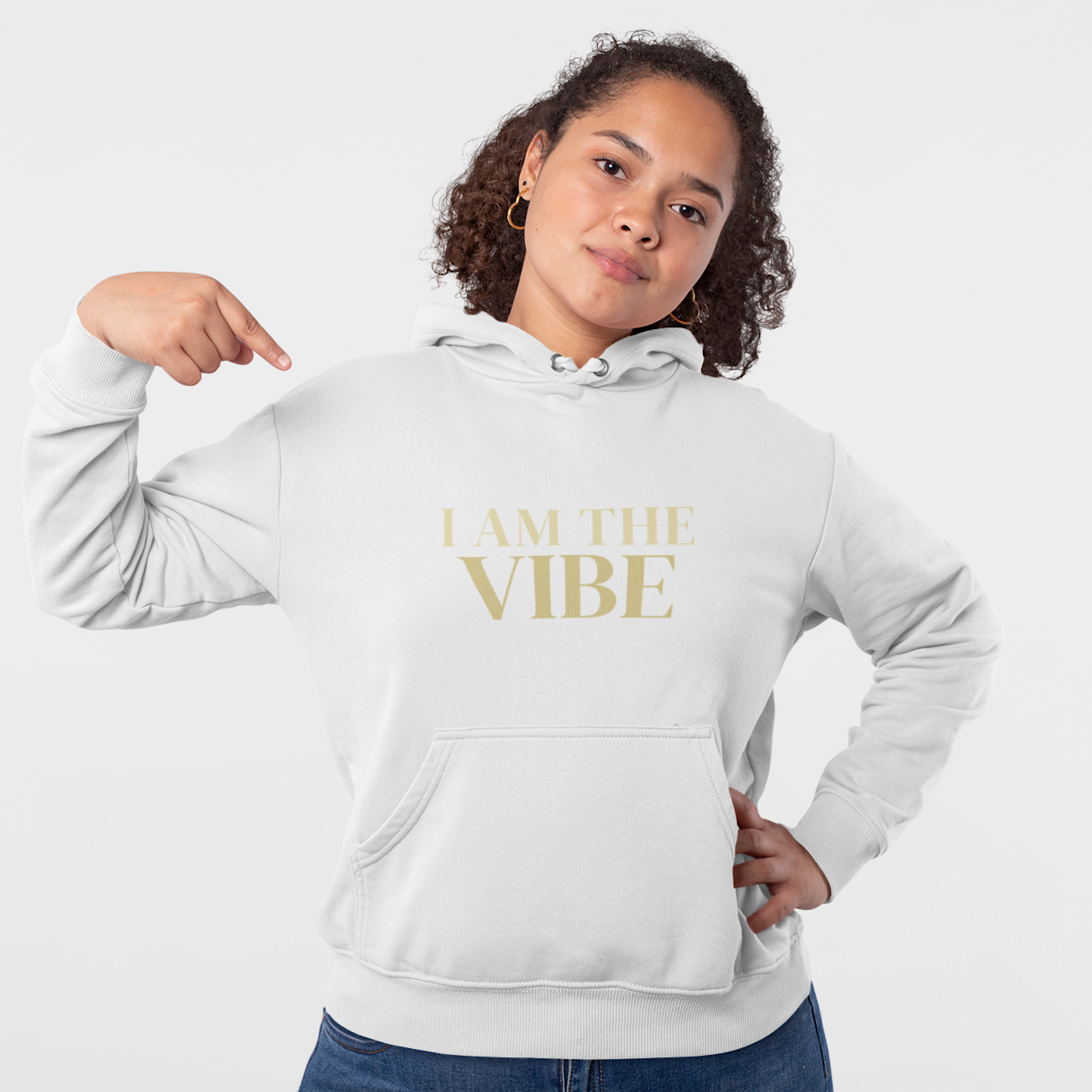 Person wearing a white hoodie with 'I AM THE VIBE' text on a plain background