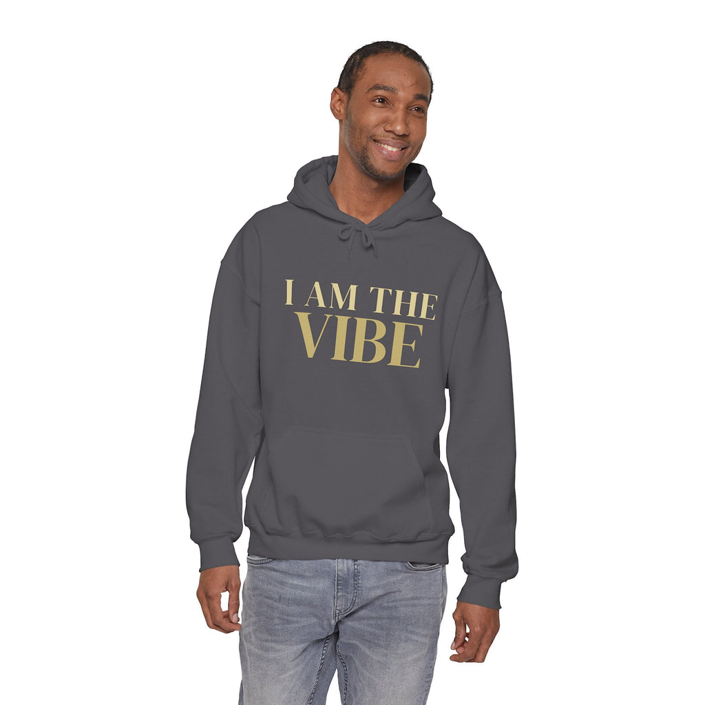 Man wearing a gray hoodie with 'I AM THE VIBE' text on a white background