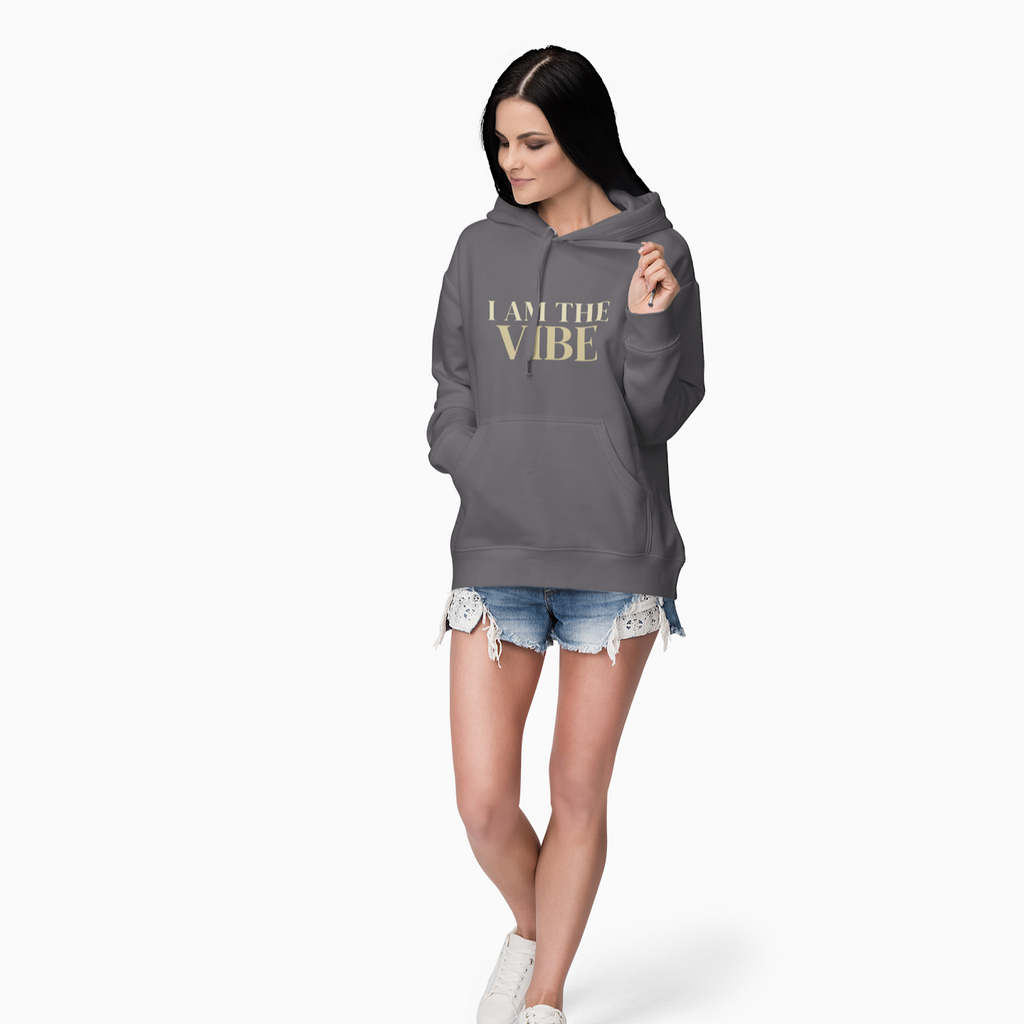 Woman wearing a gray hoodie with 'I AM THE VIBE' text on a white background