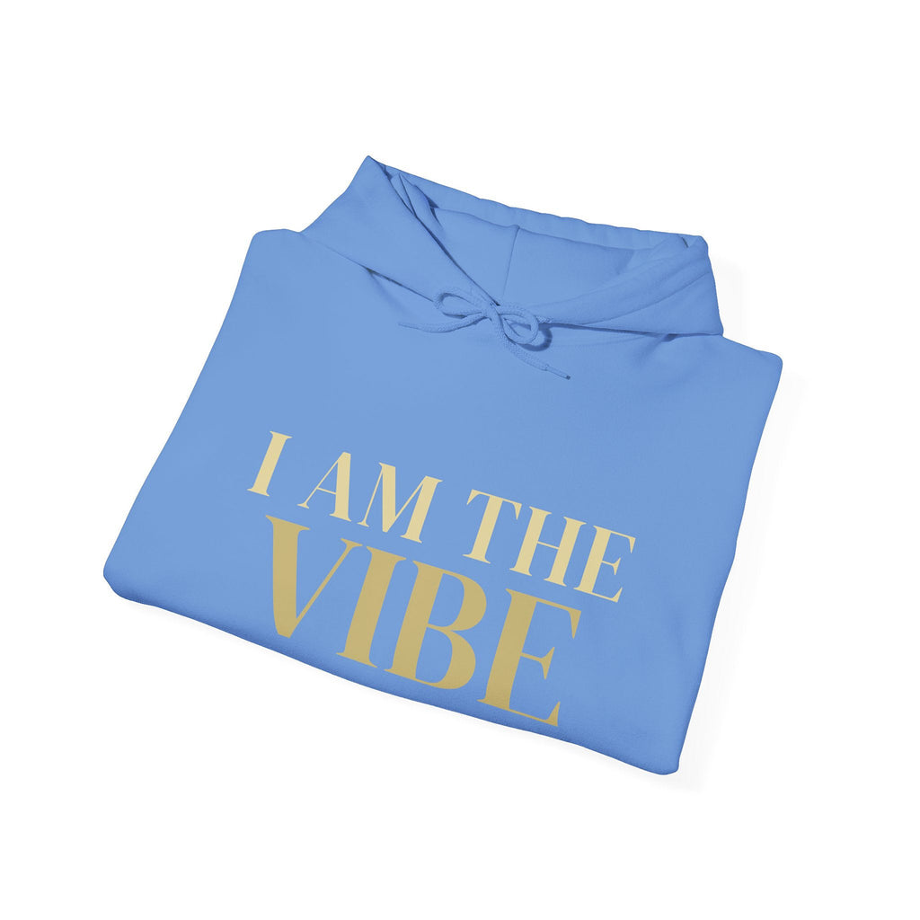 Folded blue hoodie with 'I AM THE VIBE' text on a white background