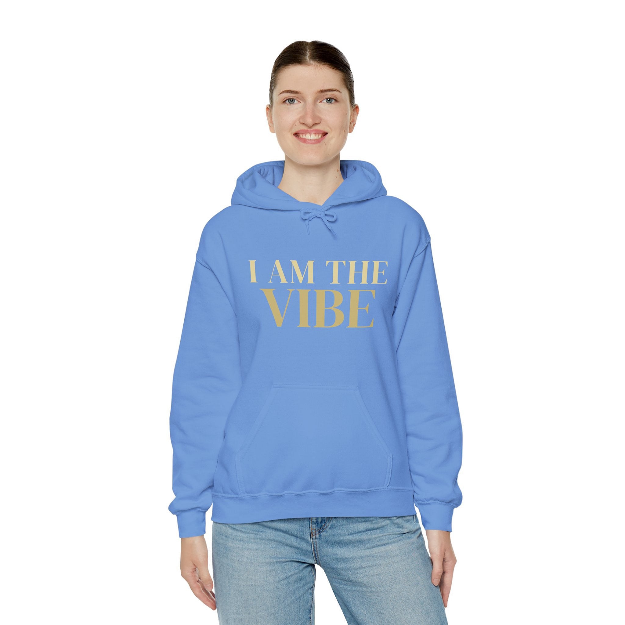 Person wearing a blue hoodie with 'I AM THE VIBE' text on a white background