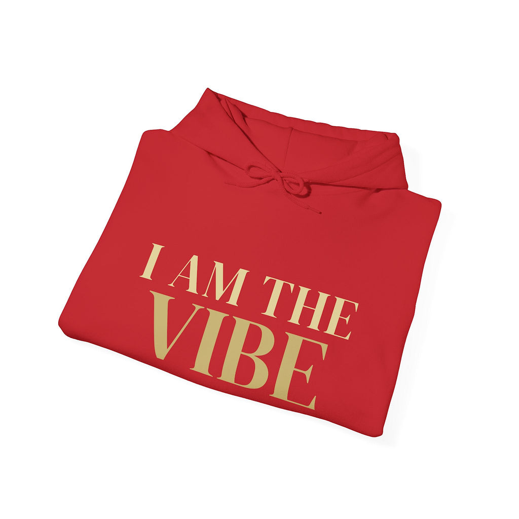 Folded red hoodie with 'I AM THE VIBE' text on a white background
