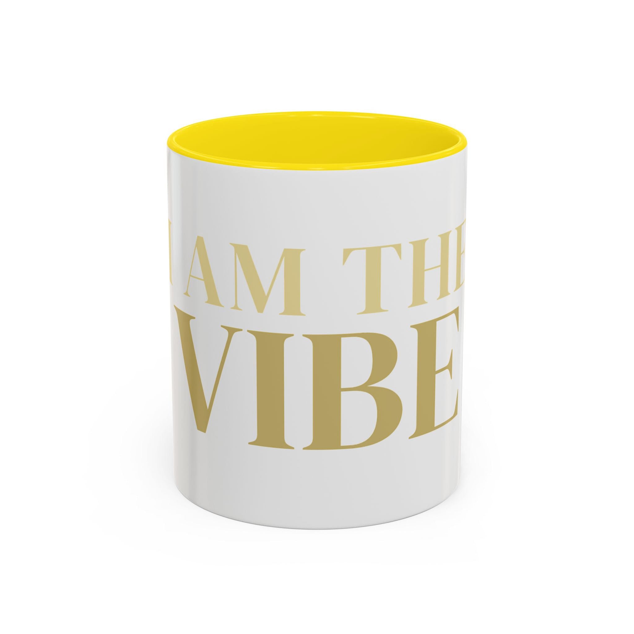 White mug with yellow interior and text 'I AM THE VIBE' on a white background