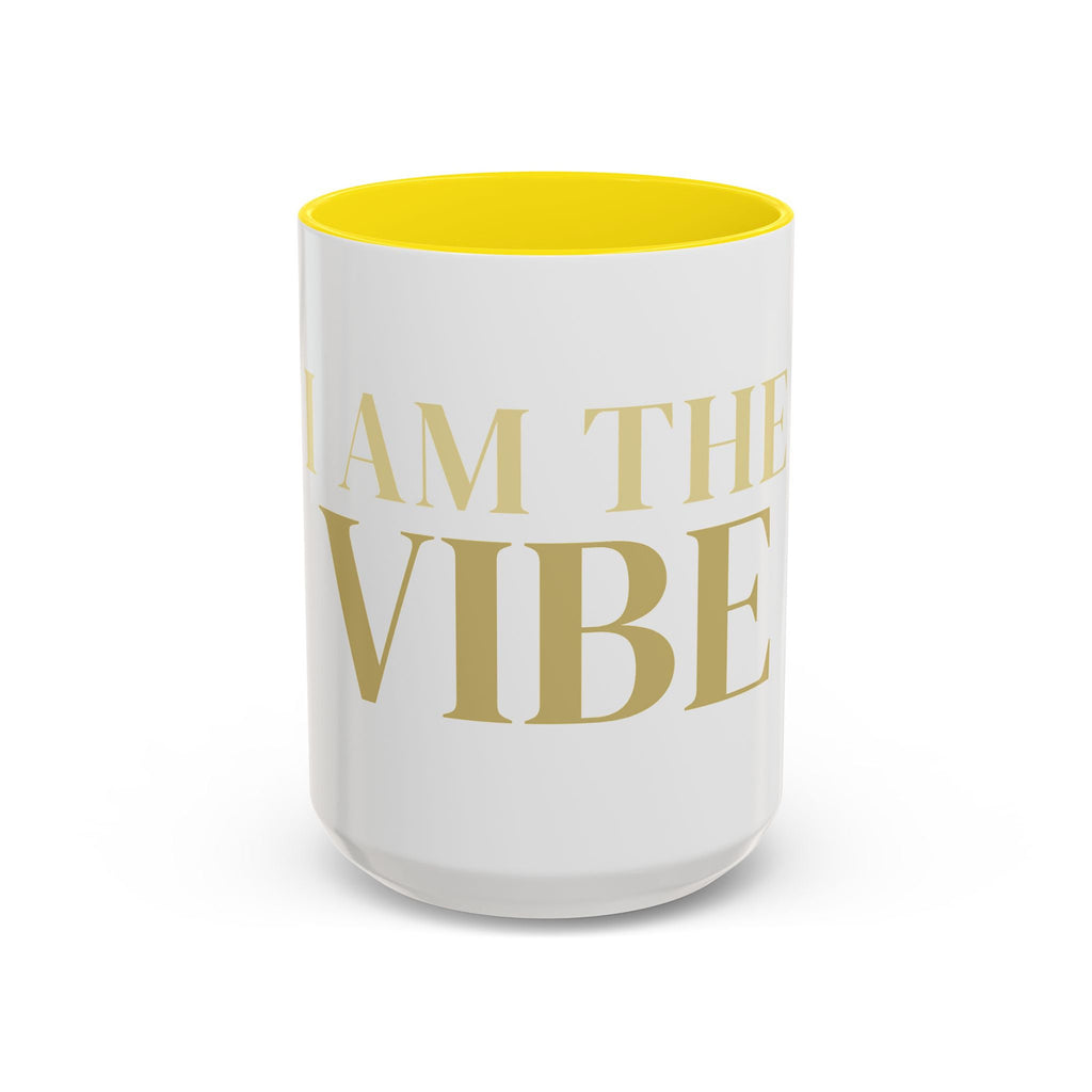 White mug with yellow interior and gold 'I AM THE VIBE' text on a white background