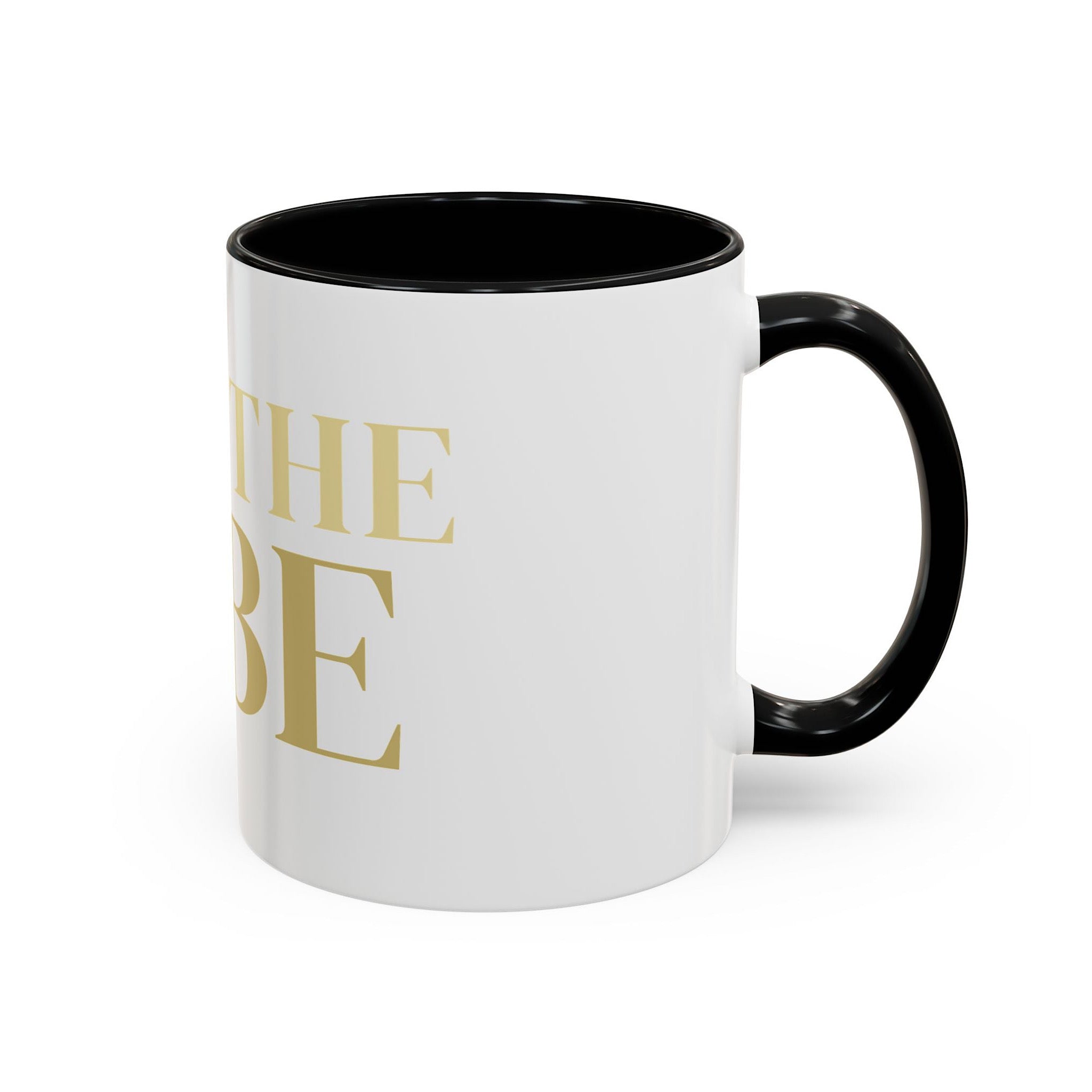 White mug with black interior and handle, featuring gold 'I AM THE VIBE' text on a white background