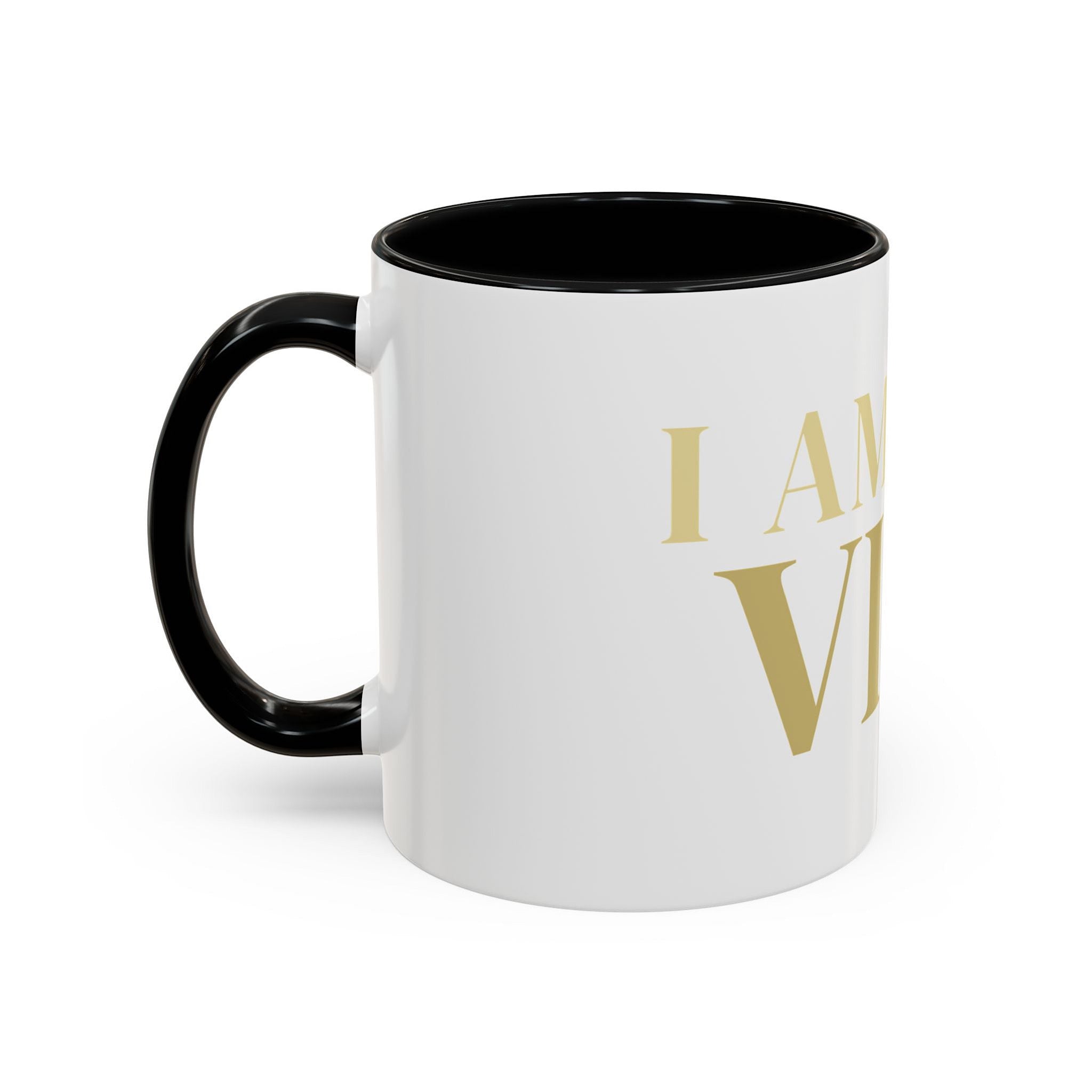 White mug with black handle and gold text on a white background