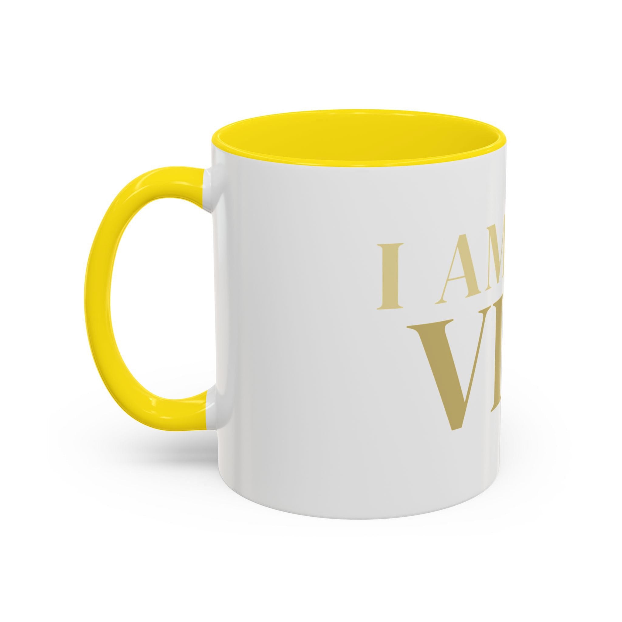 White mug with yellow interior and handle, featuring the text 'I AM THE VIBE' in gold.