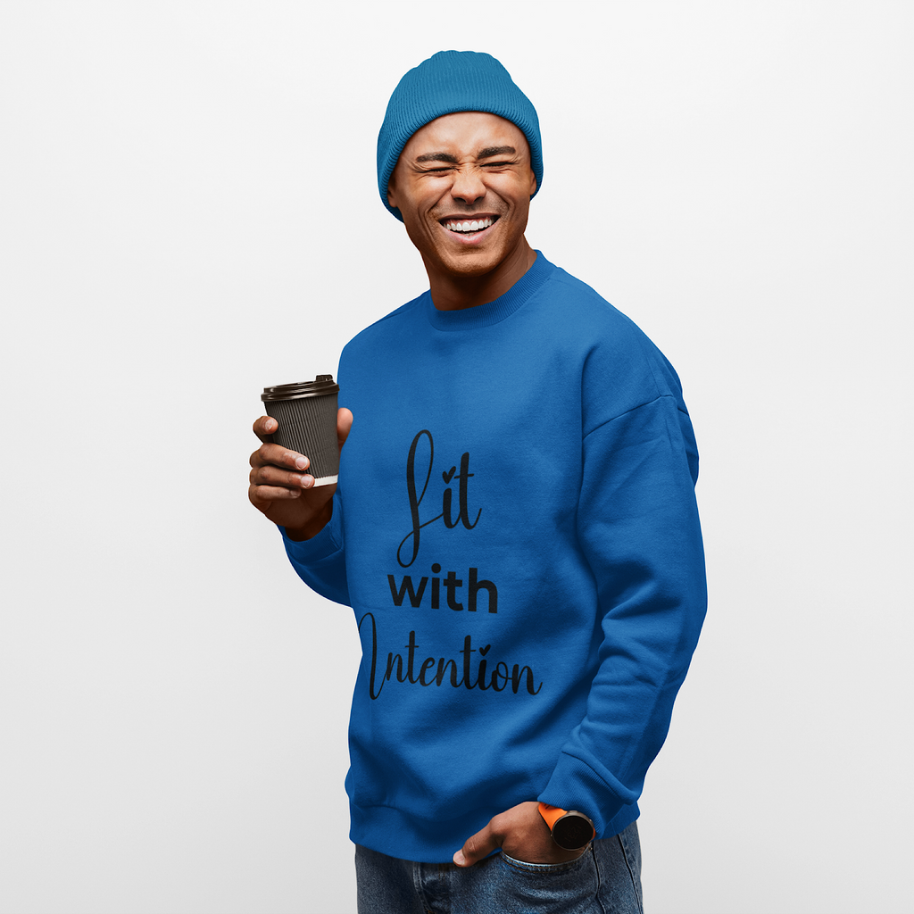 Man wearing a blue sweatshirt with 'Lit with Intention' text, holding a coffee cup.