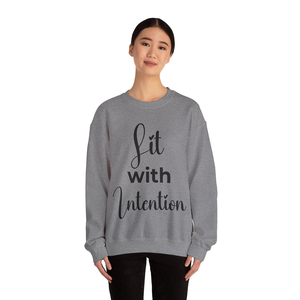 Person wearing a gray sweatshirt with 'Lit with Intention' text design on a white background