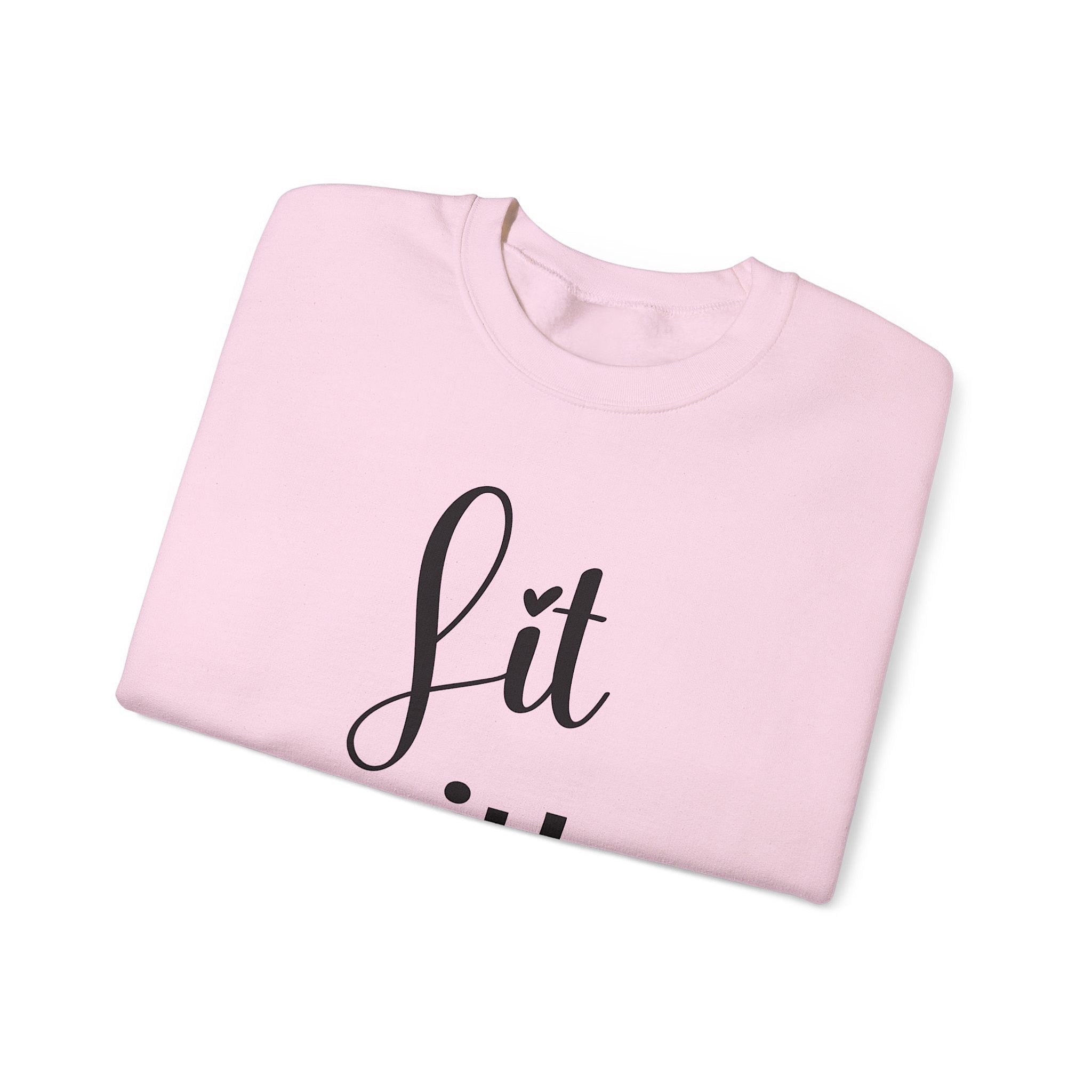 Folded pink sweatshirt with 'Lit with Intention' text on a white background