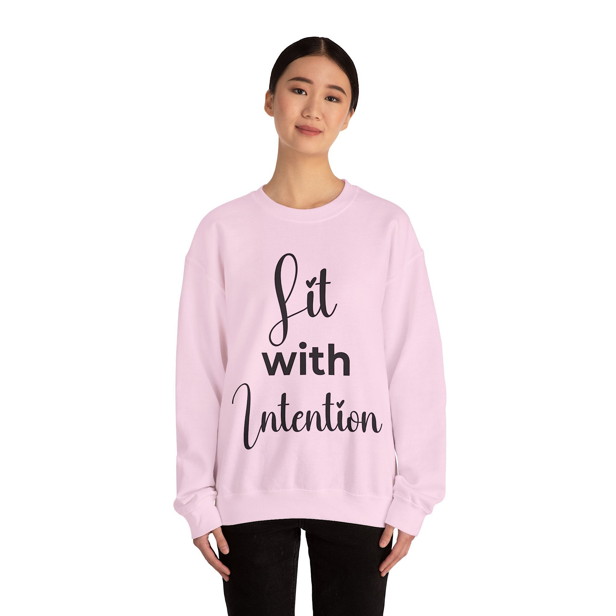 Person wearing a white sweatshirt with 'Lit with Intention' text on a white background