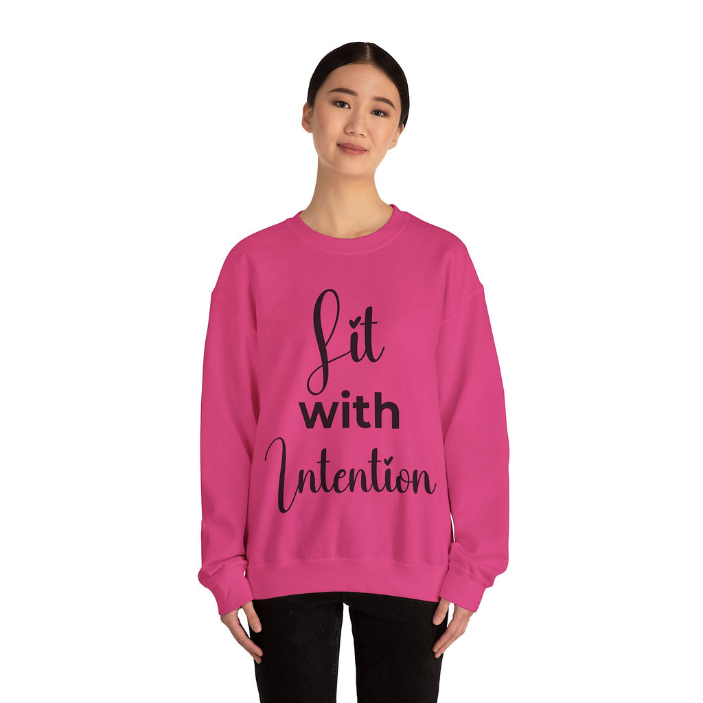 Person wearing a pink sweatshirt with 'Lit with Intention' text on a white background