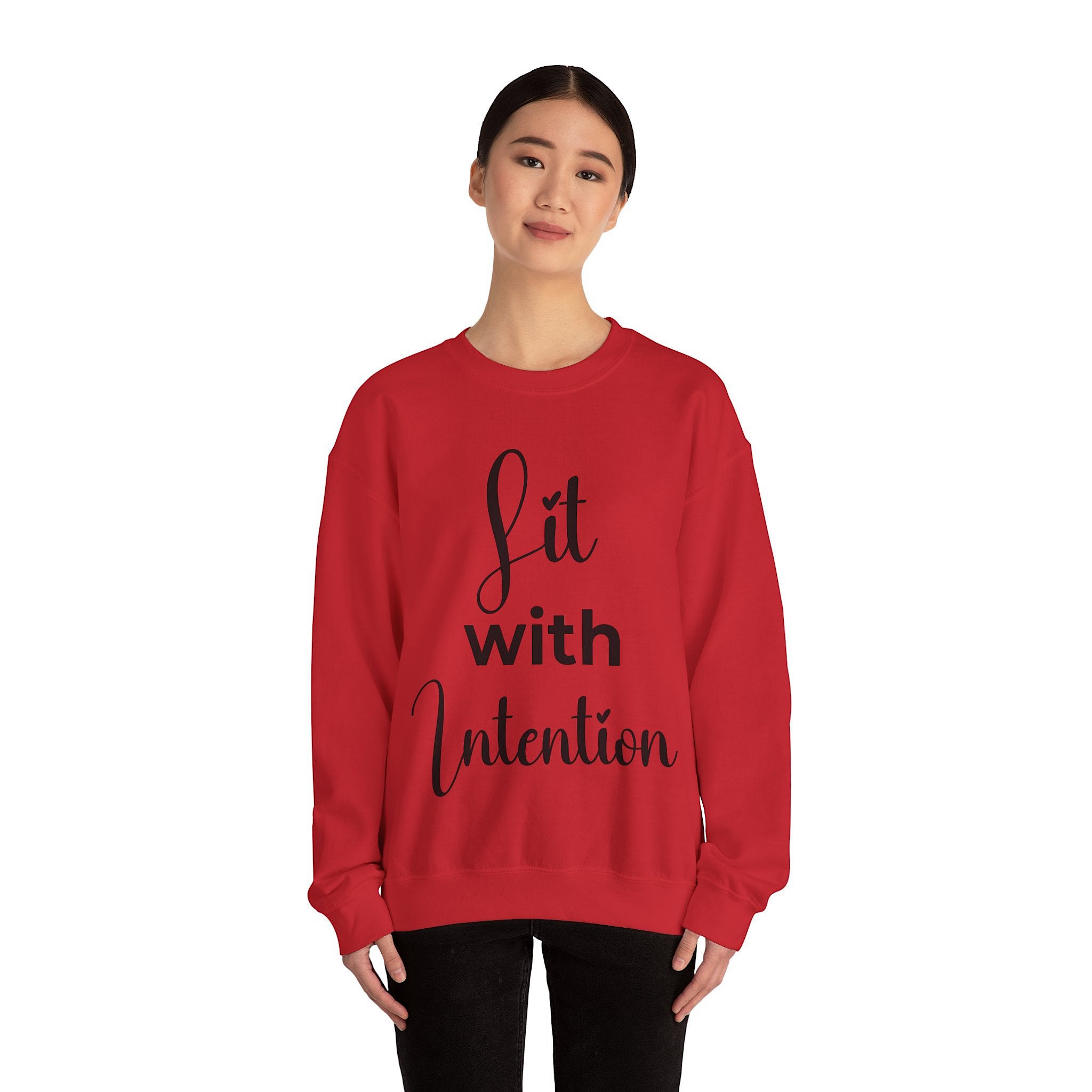 Person wearing a red sweatshirt with 'Lit with Intention' text on a white background