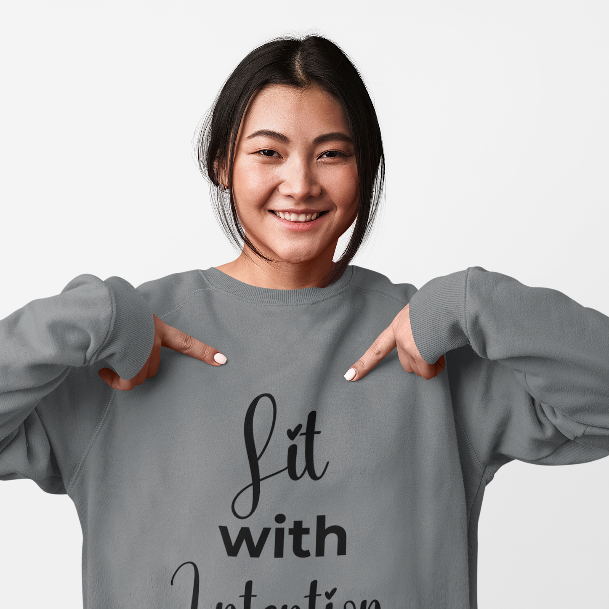 Person wearing a gray sweatshirt with 'Lit with Intention' text on a plain background