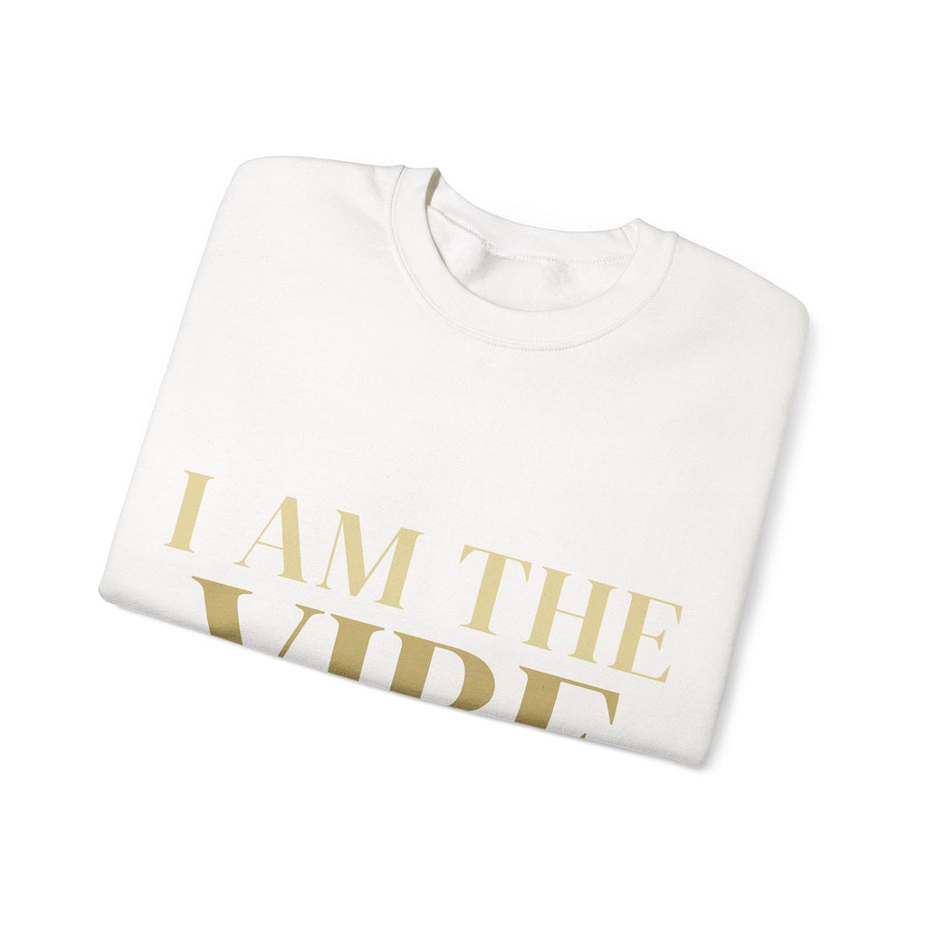 White sweatshirt with 'I AM THE VIBE' text in gold on a white background