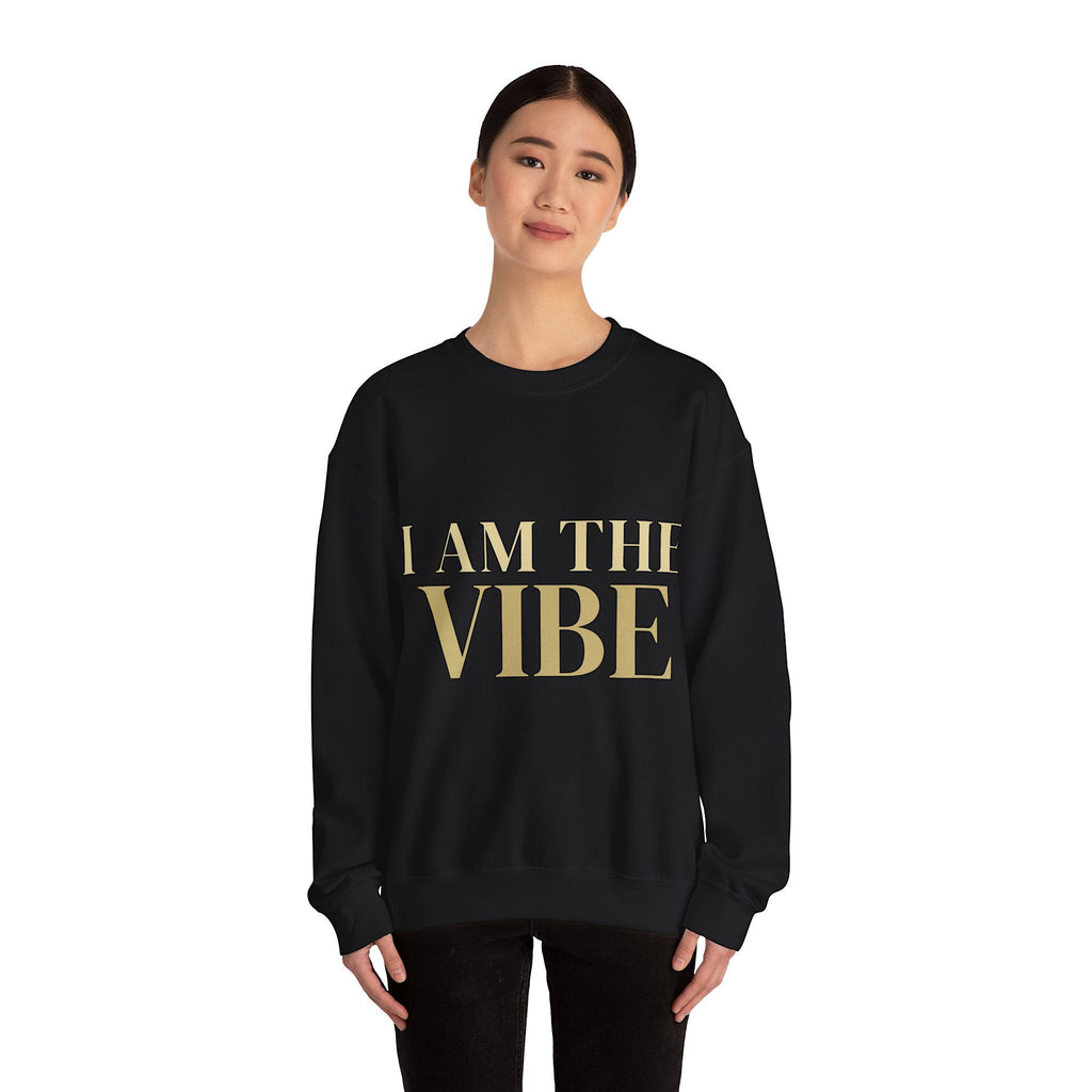 Person wearing a black sweatshirt with a graphic design 'I AM THE VIBE' text on a white background