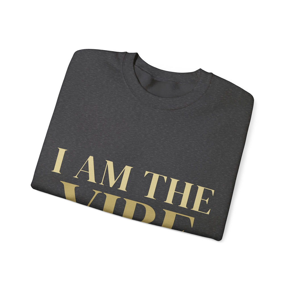 Folded navy blue sweatshirt with 'I AM THE VIBE' text on a white background