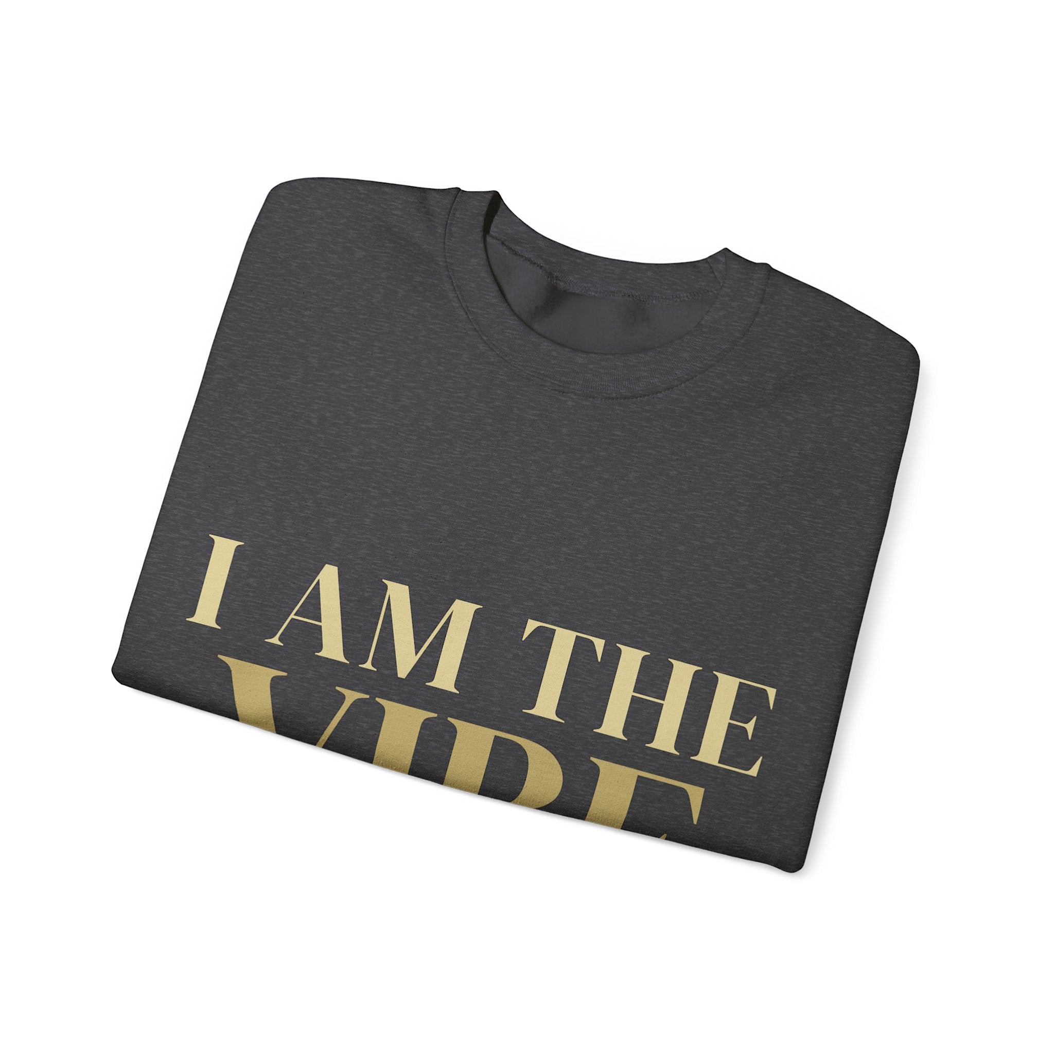 Folded navy blue sweatshirt with 'I AM THE VIBE' text on a white background