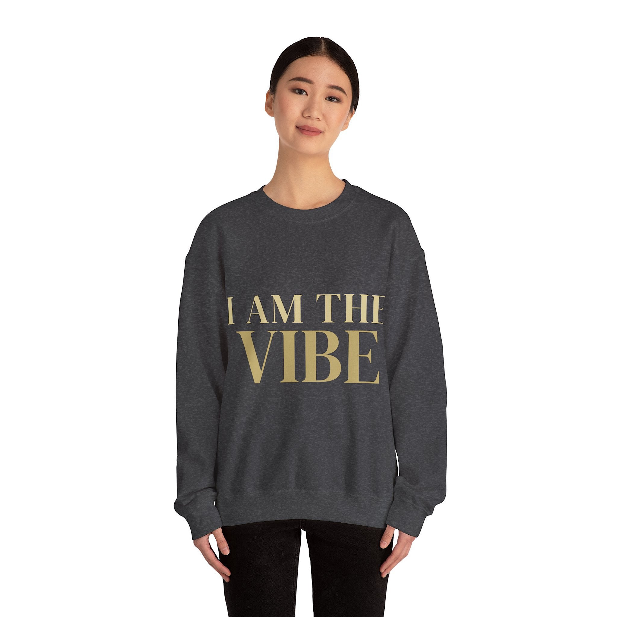 Person wearing a dark gray sweatshirt with 'I AM THE VIBE' design on a white background