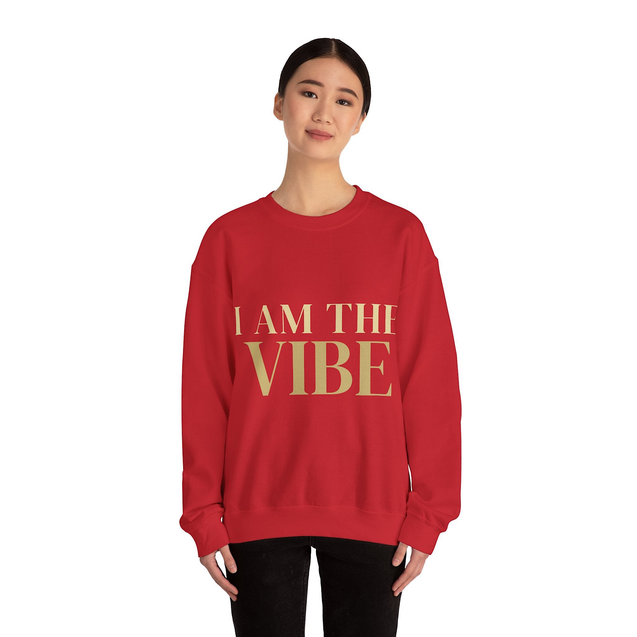 Person wearing a red sweatshirt with 'I AM THE VIBE' text on a white background