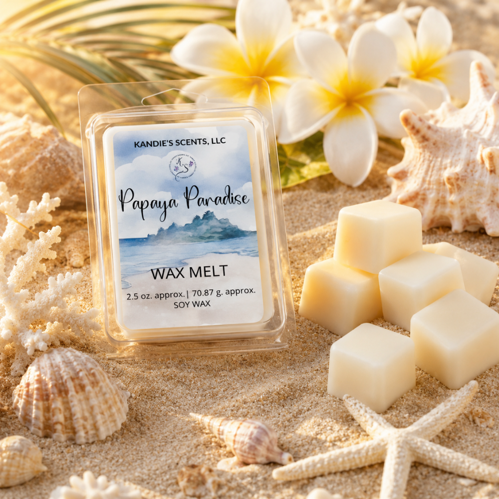 Kandie's Scents Papaya Paradise wax melt packaging on sand with flowers and shells