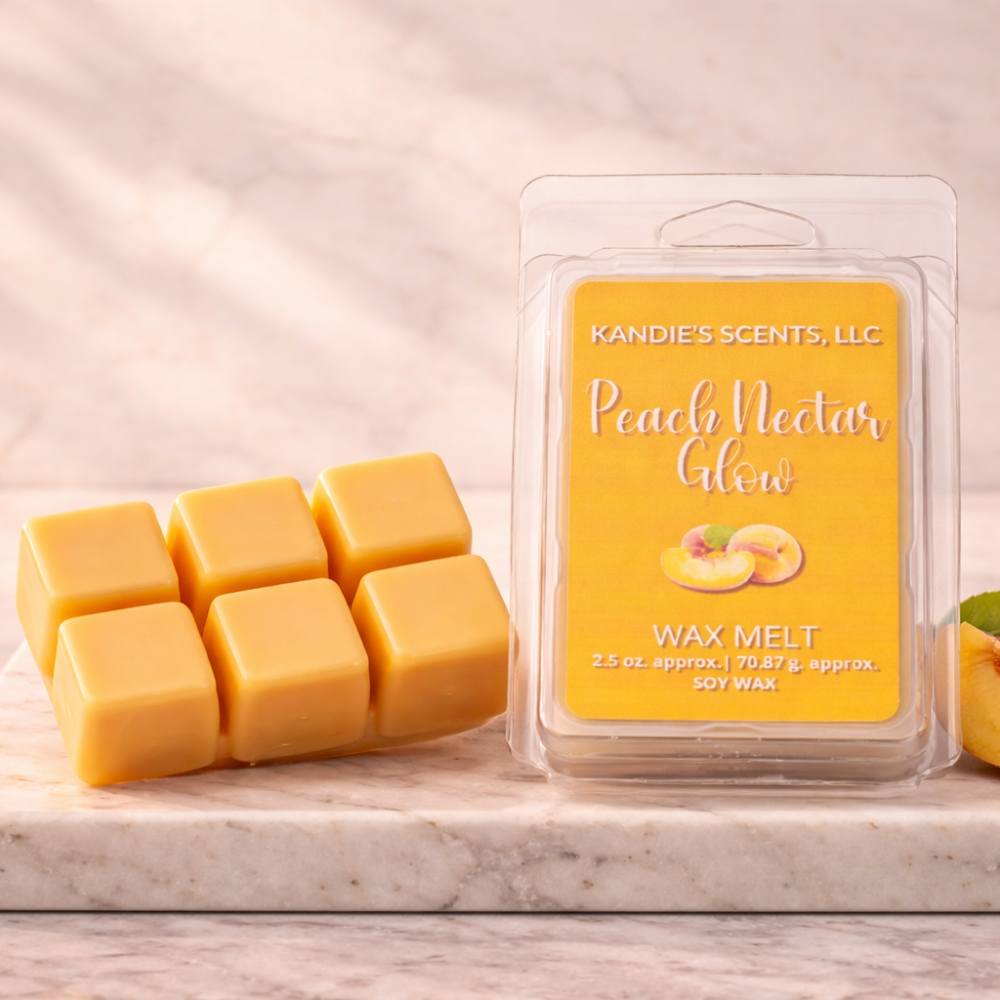 Kandie's Scents Peach Nectar Glow wax melts packaging on a marble surface with a soft pink background
