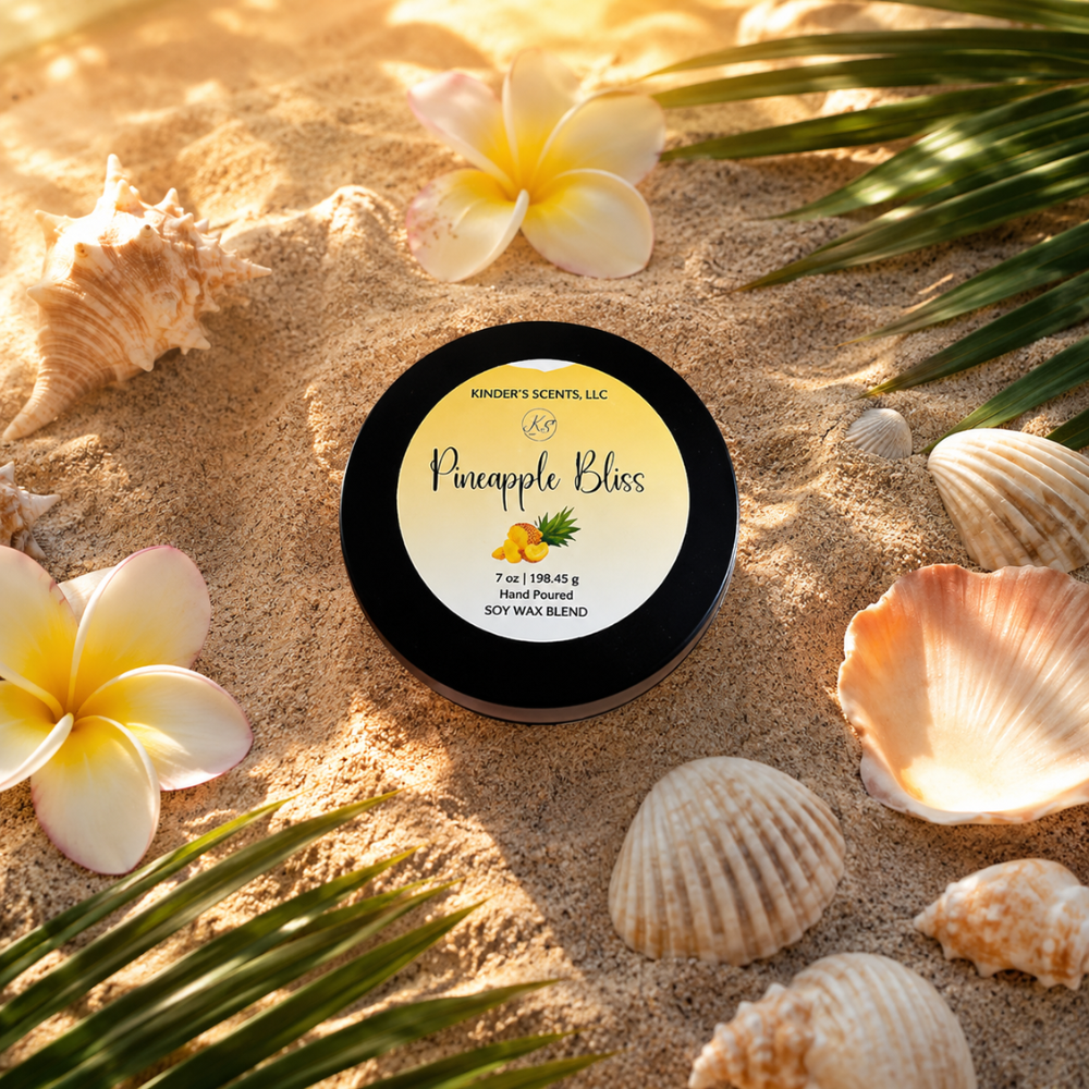 'Pineapple Bliss' candle tin on sand with flowers and shells