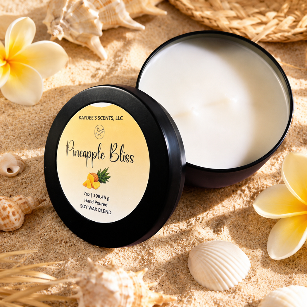 Scented candle labeled 'Pineapple Bliss' on sand with flowers and shells