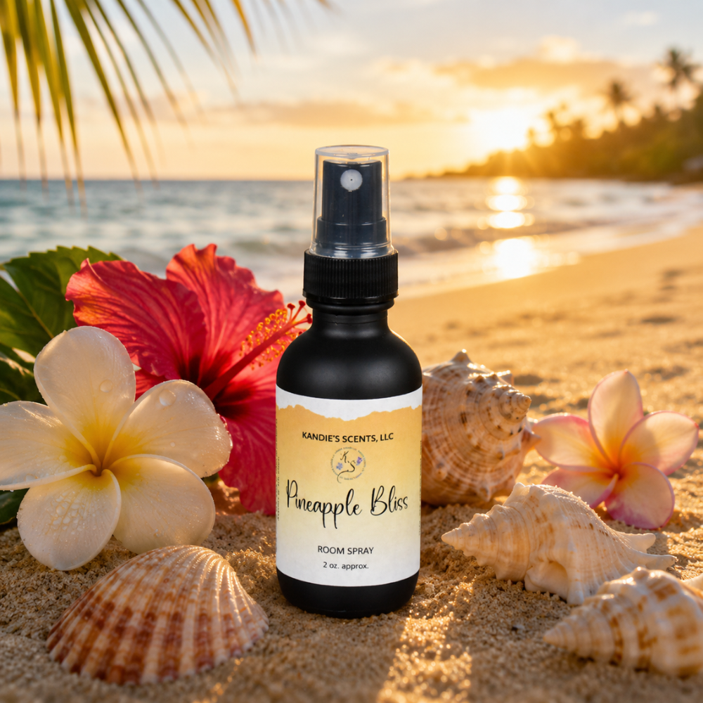 Room spray bottle labeled 'Pineapple Bliss' on a beach with flowers and shells.