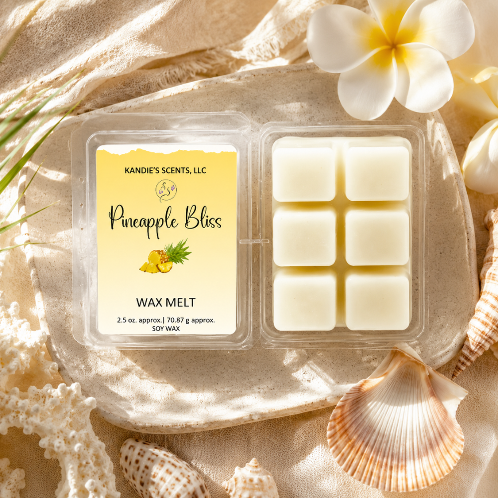Pack of Kandie's Scents Pineapple Bliss wax melts with decorative elements on a sandy background