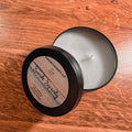Matte black tin candle with coastal floral fragrance