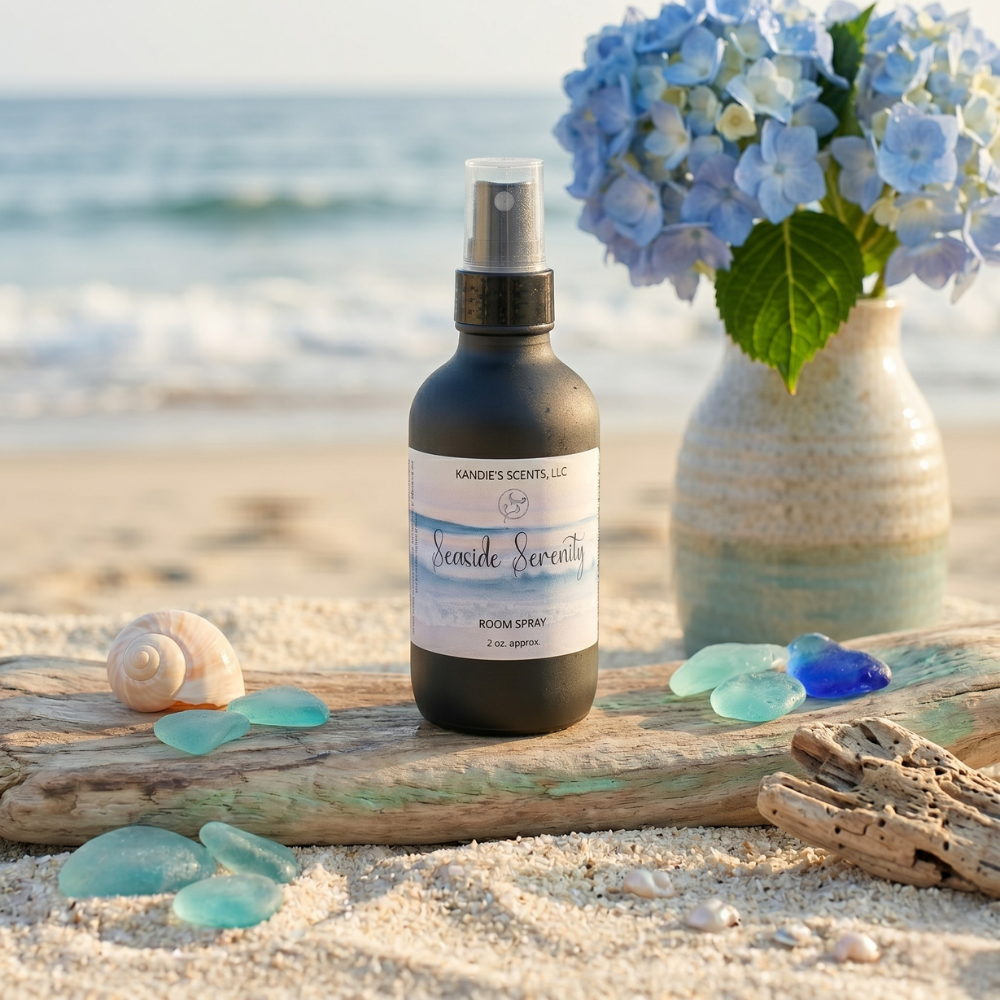 Room spray bottle on driftwood with beach elements and flowers in the background