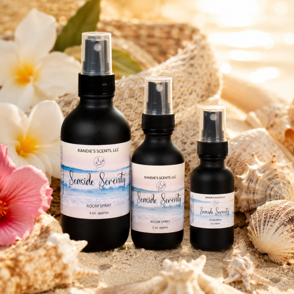 Three 'Seaside Serenity' room spray bottles on a beach-themed background with flowers and shells.