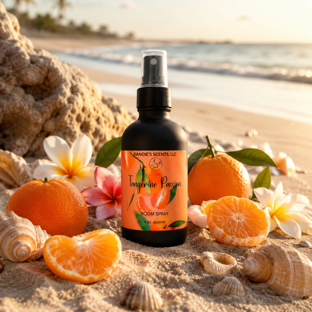 Bottle of Tangerine Passion room spray on a beach with oranges and flowers