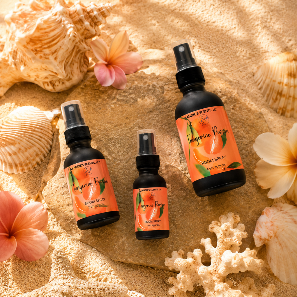 Three bottles of 'Tangerine Passion' room spray on sand with shells and flowers