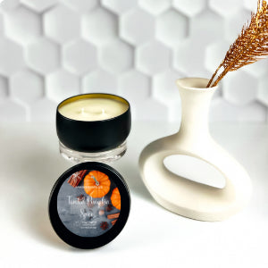 Matte black travel tin candle with cozy fall fragrance