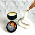 Matte black travel tin candle with cozy fall fragrance